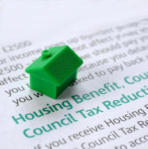 Monopoly house piece on document with benefits